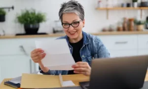 A female investor looking at the Dividend Payout she received from her ASX stocks